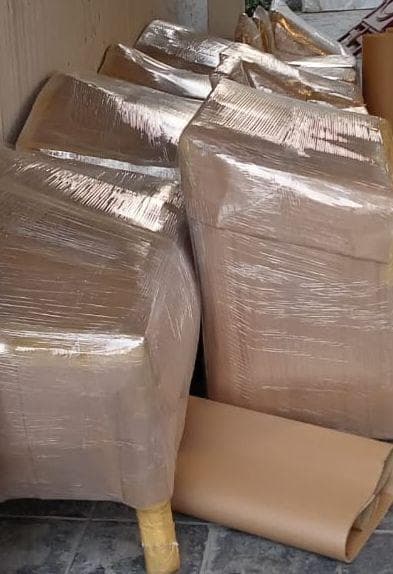 Sofa sets wrapped with cardboard and stretch film